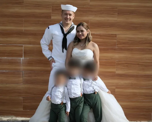 Jai Bailey in Navy dress whites with his wife and their three sons